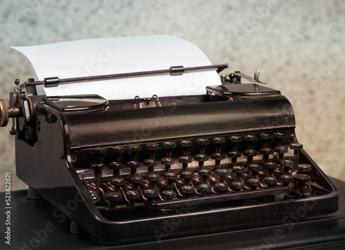 Vintage old typewriter at desk table. Writer or screenwriter creative concept