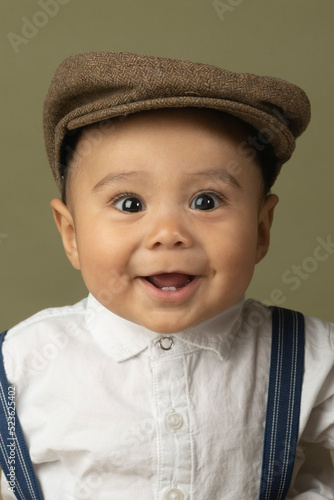 Cute funny baby dressed up like a newsboy 