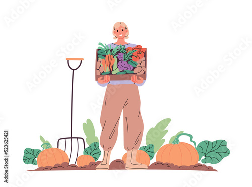 Farmer in garden with box of vegetables