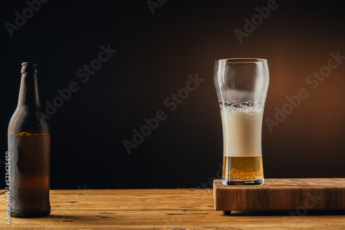 glass of beer with foam half full