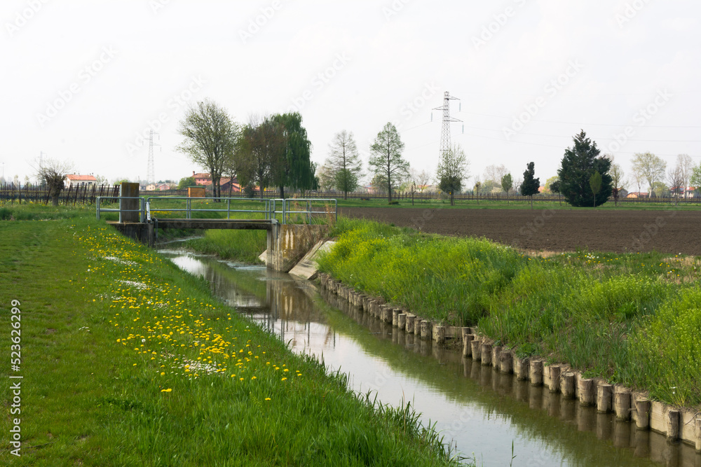 Landscape with a canal and a bridge in the rural side of Meolo Town, Veneto, Italy