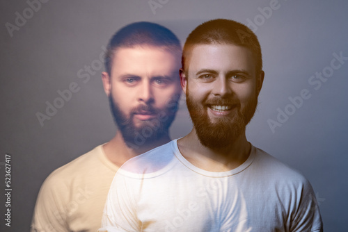 Portrait of two-faced man in calm serious and happy expression. Different emotion inside and outside mood. Internally suffering, dissociative identity disorder. Double exposure. indoor, studio shot