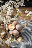 Handmade donuts with white spring flowers at the background 