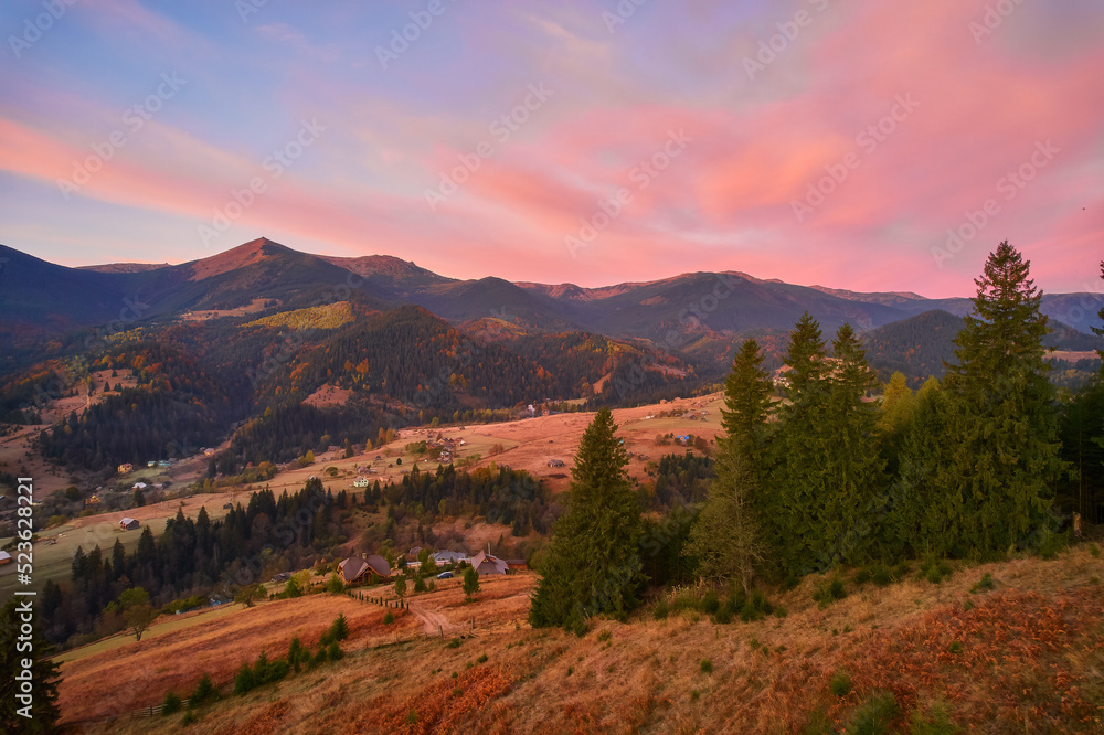 Mountain forest landscape under evening sky with clouds in sunlight. Mountain forest landscape under evening sky with clouds in sunlight.