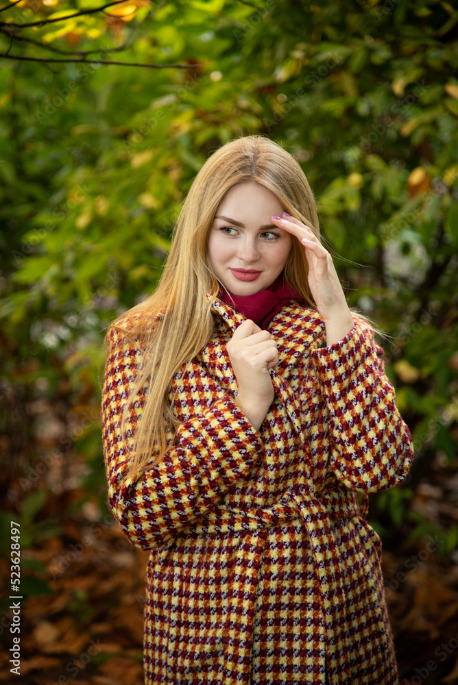 beautiful blonde young smiling girl walking in autumn park beautiful blonde young smiling girl walking in autumn park