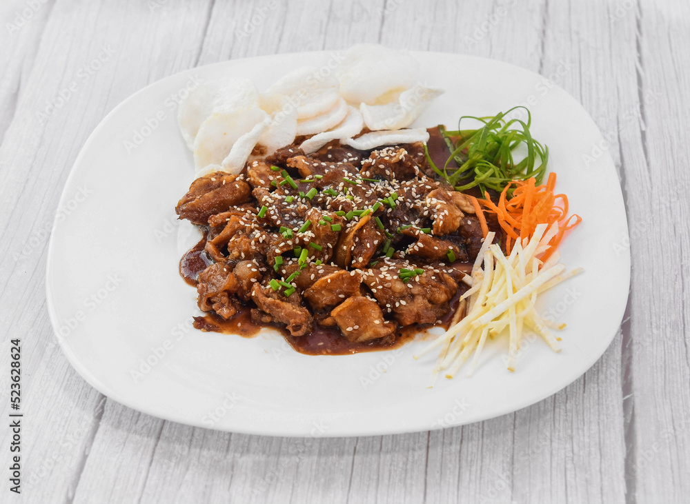 Beef Bulgogi served in dish isolated on grey wooden background side view of fastfood