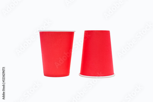 Disposable red cardboard coffee cups isolated on white background. Disposable cups for drinks or coffee. Cardboard eco-friendly disposable cups for picnic or drinking outside