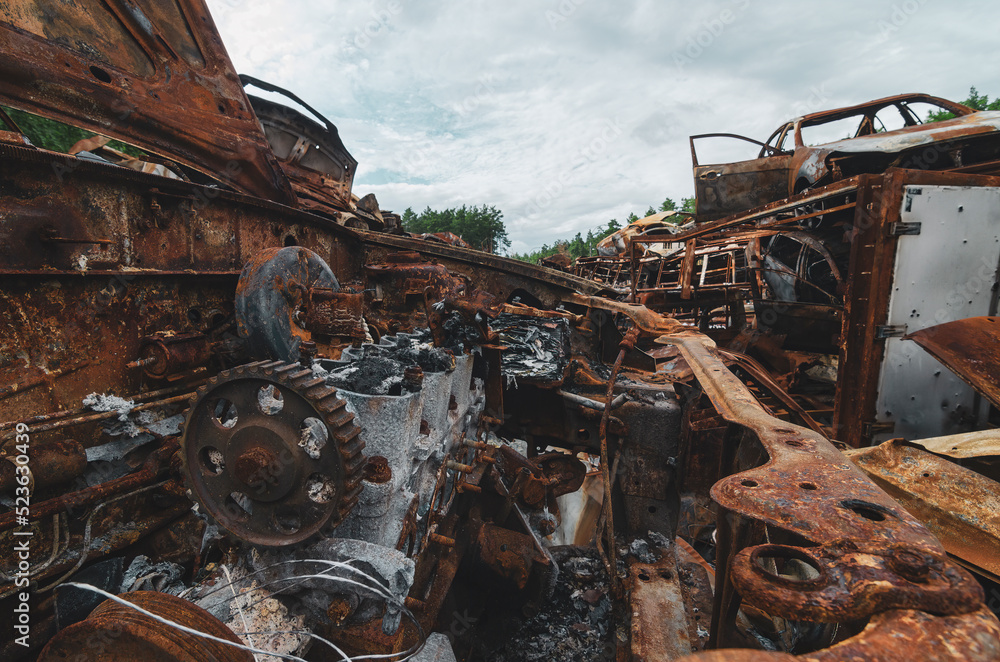 Cemetery of rusted and burned disposed cars