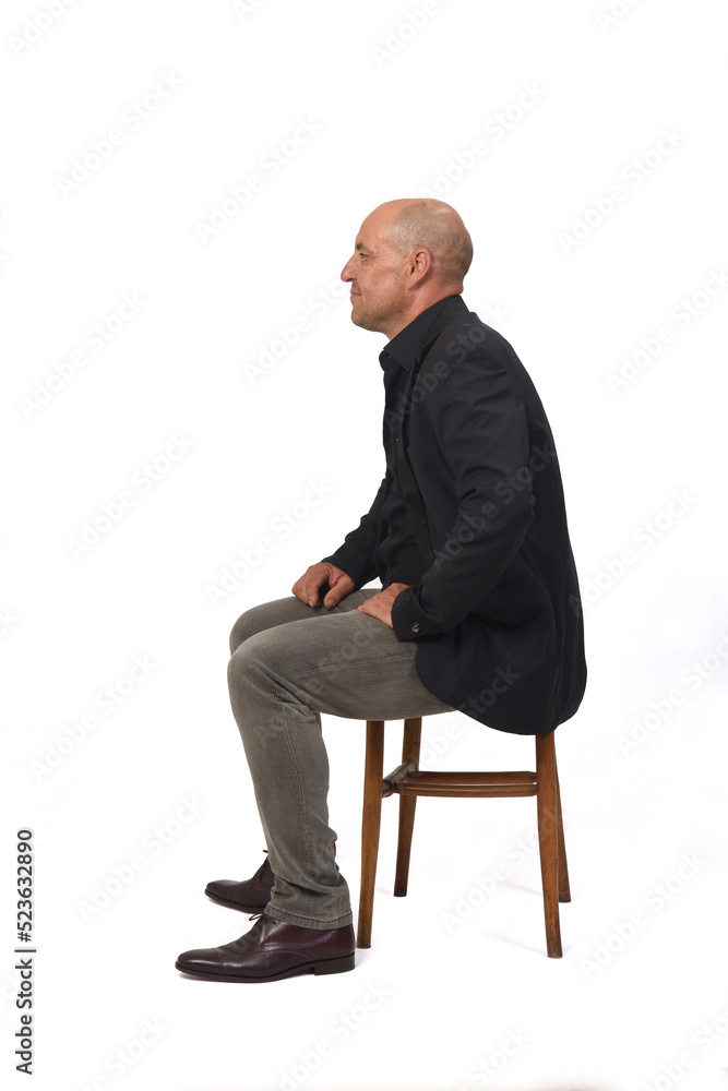 side view of a full portrait of a man sitting on chair with cross-legged on white background side view of a full portrait of a man sitting on chair with cross-legged on white background