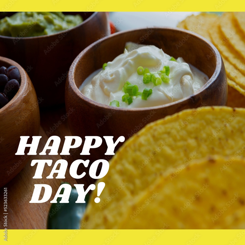 Fototapeta premium Composition of happy taco day text with tacos on table