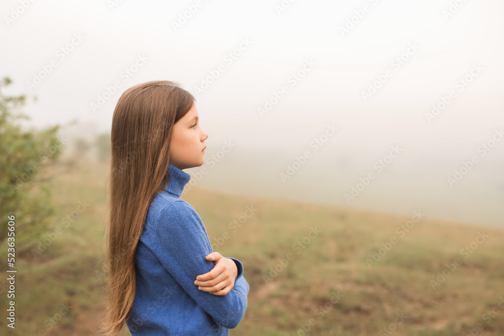 Long-haired girl walking on a foggy morning Long-haired girl walking on a foggy morning