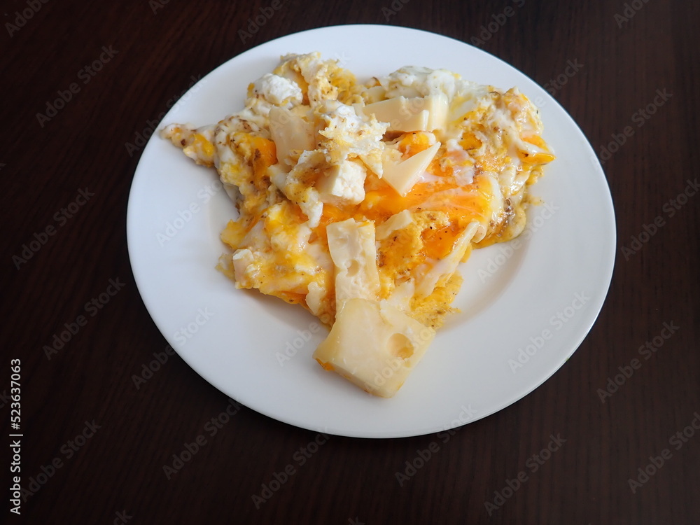 scrabbled eggs with vegetales served on a plate
