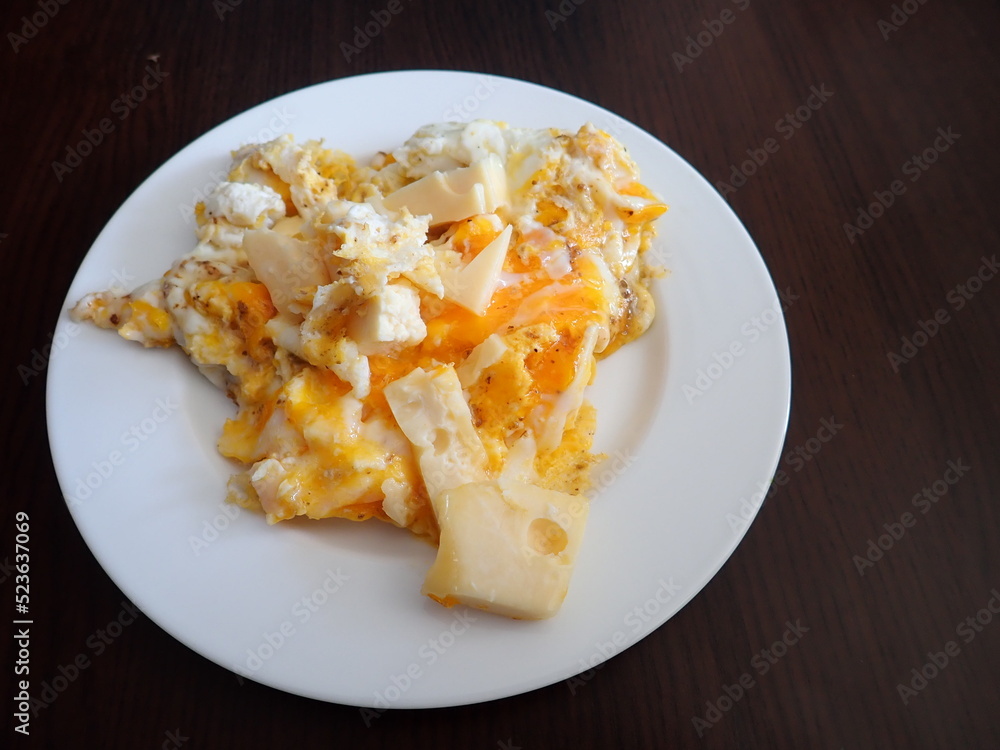 scrabbled eggs with vegetales served on a plate scrabbled eggs with vegetales served on a plate