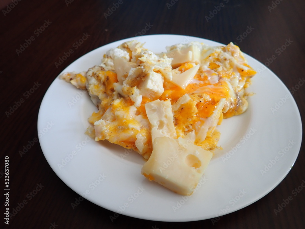scrabbled eggs with vegetales served on a plate scrabbled eggs with vegetales served on a plate
