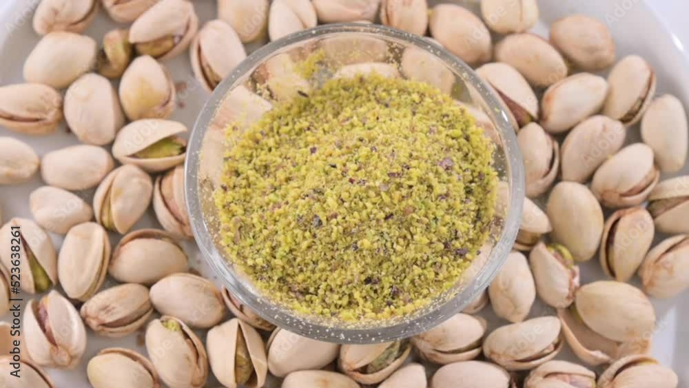 Pistachios. Nuts pistachios with shells and ground in a cup. Closeup