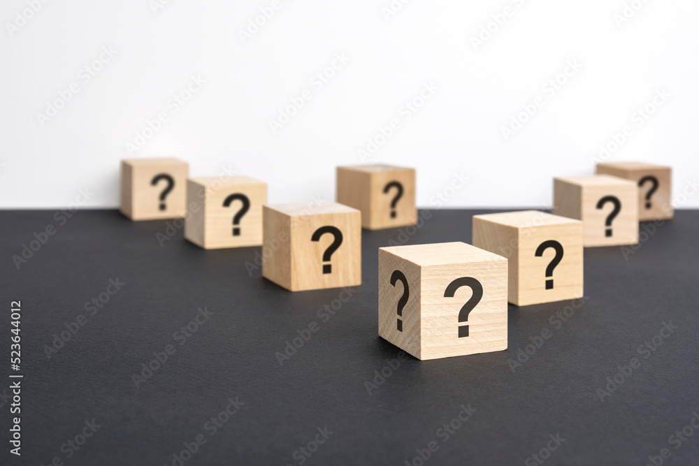 front view on many wood cubes with question marks. many question arising concept front view on many wood cubes with question marks. many question arising concept