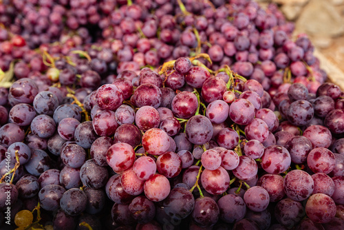 Selective focus of purple grapes group. Purple grapes at a Farmer's Market. 