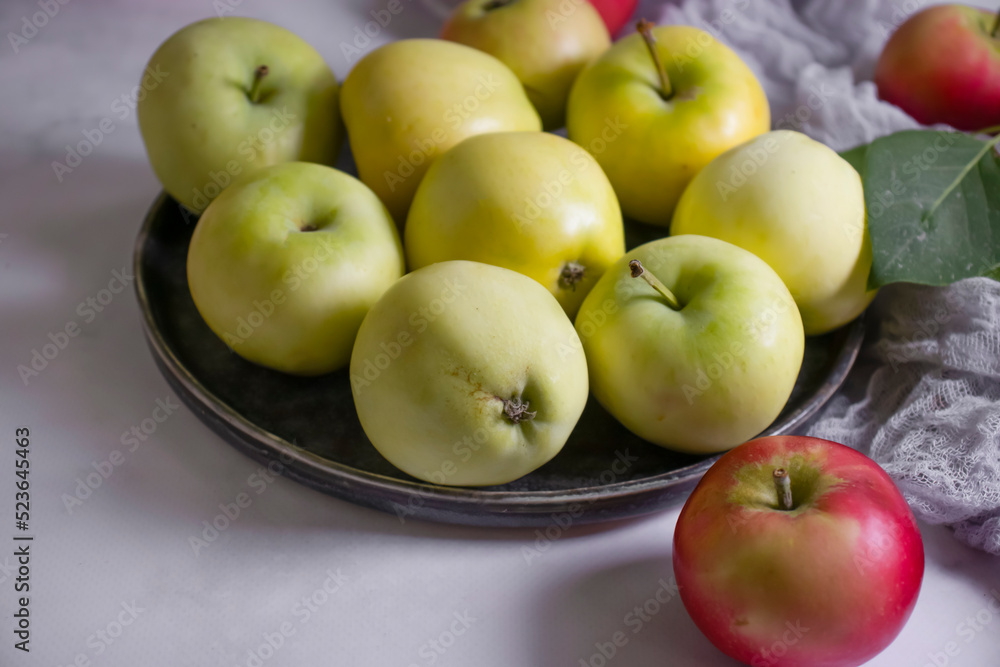 Fresh apples with leaves on a light background Fresh apples with leaves on a light background
