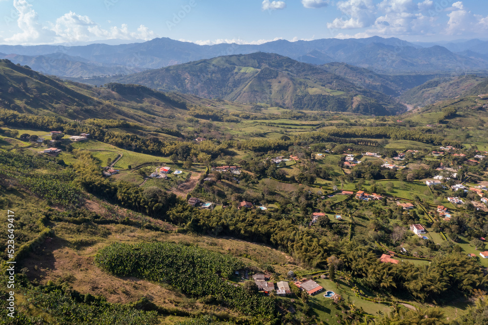 View from a drone of crop fields and farms between mountains. Colombia.