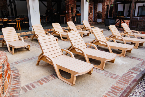 empty sunbeds by the pool. furniture for the garden and recreation areas.