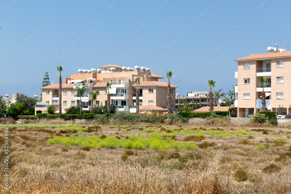 Residential buildings in the city of Paphos. Cyprus. Bright houses in the sunshine.