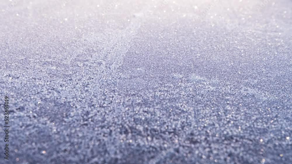 Plain surface covered with fresh white hoar frost. Beautiful, glittering morning sunshine on a cold winter day. Sparkling, continuous changing natural reflections. Calm nature scene for a background. Plain surface covered with fresh white hoar frost. Beautiful, glittering morning sunshine on a cold winter day. Sparkling, continuous changing natural reflections. Calm nature scene for a background.