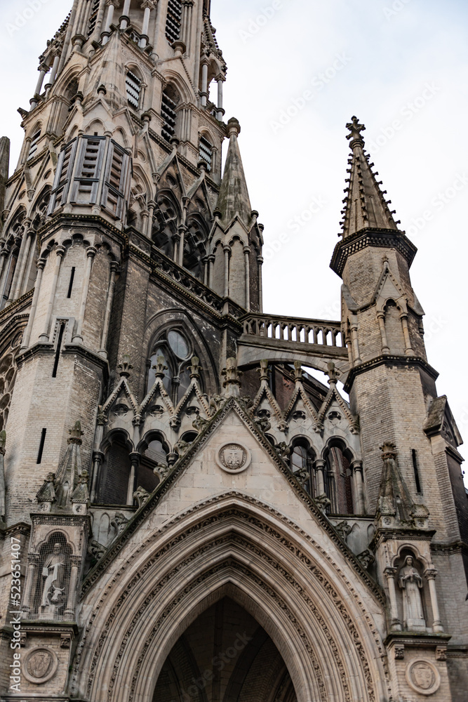 Fototapeta premium european midevil gothic church cathedral entrance and tower brick