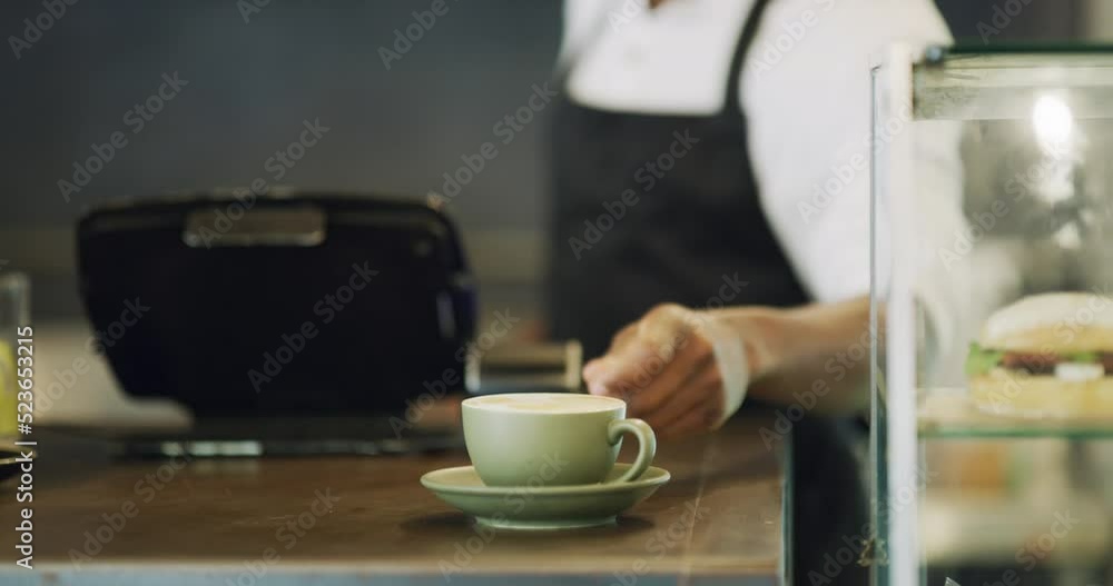 Waiter hands serving cup of coffee, tea and hot drink in a local cafe, small restaurant or bar. Closeup of man and server wearing an apron and giving warm, comforting and delicious beverage in a mug Waiter hands serving cup of coffee, tea and hot drink in a local cafe, small restaurant or bar. Closeup of man and server wearing an apron and giving warm, comforting and delicious beverage in a mug