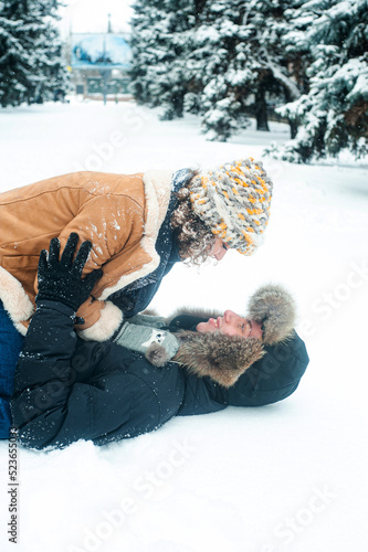 happy young family in love and playing on the snow in winter park