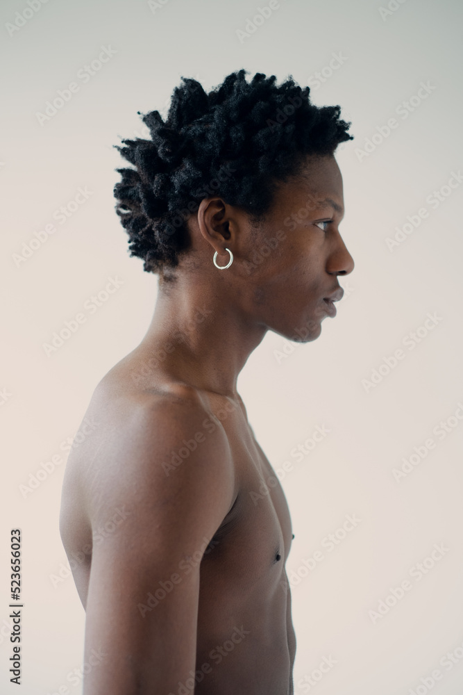 silhouette of a muscular african man posing in a photo studio on a white background without a t-shirt close-up portrait silhouette of a muscular african man posing in a photo studio on a white background without a t-shirt close-up portrait