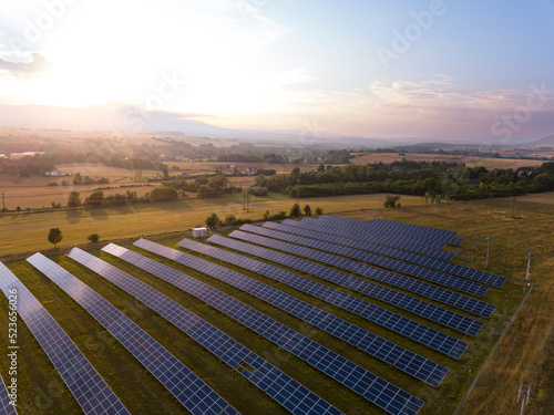 Solar farm system on a field. Green energy renewable resources climate change and clean environment background.