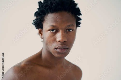 silhouette of a muscular african man posing in a photo studio on a white background without a t-shirt close-up portrait