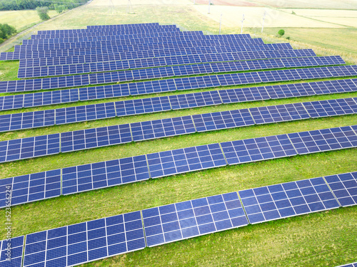 Solar panels  farm on a field. Green energy renewable resources and clean environment background.