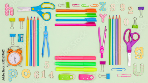 Pastel green background with copy space and Back to school stationery. Flat lay