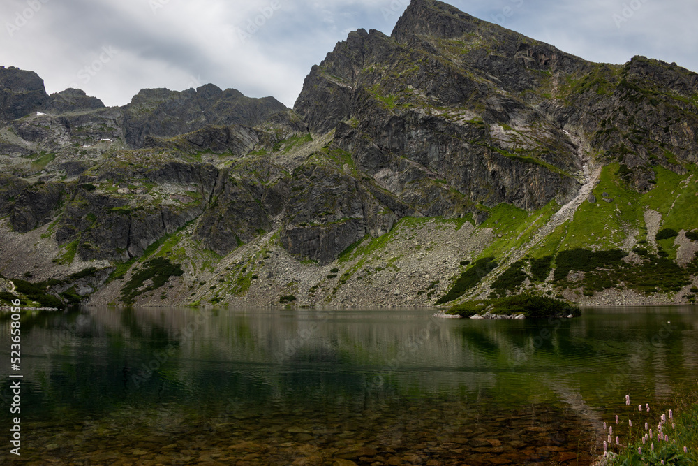 Czarny Staw lake on a hiking trail towards Zawrat mountain pass from Murowaniec Mountain Hut in July, Tatry mountains, Poland