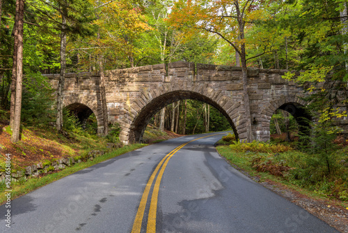 Stanley Brook Bridge - A wide-angle Autumn morning view of triple-arched Stanley Brook Bridge, one of sixteen Rockefeller's unique carriage-road stone-faced bridges, in Acadia National Park, ME, USA.