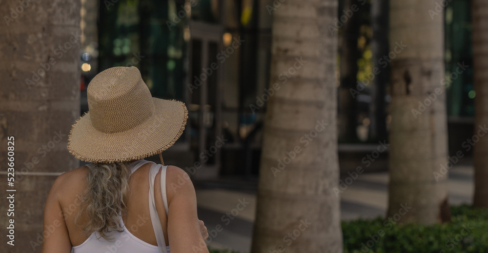woman in hat tropical miami palms 