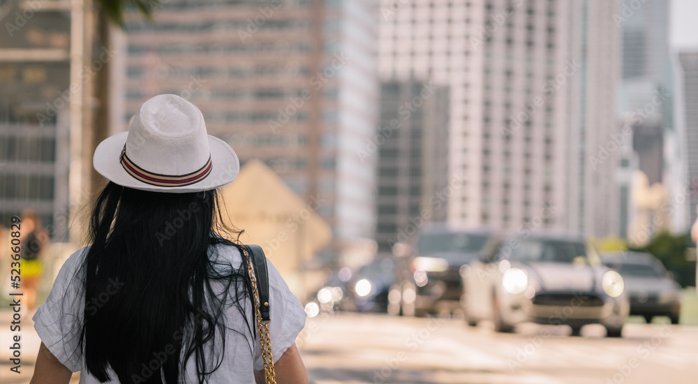 woman walking in the city hat summer miami 
