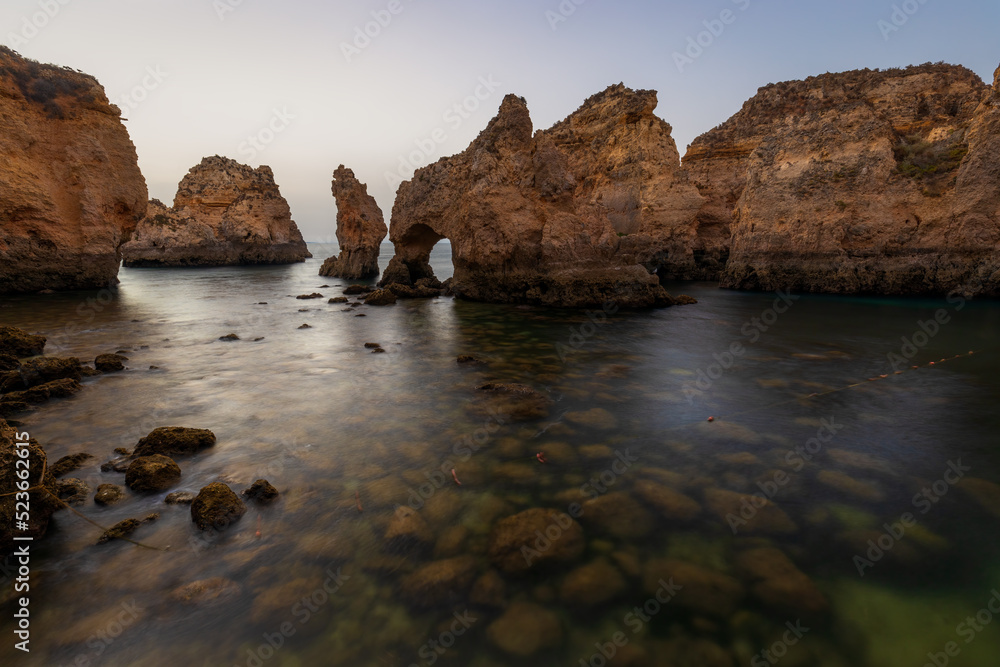Landscape with rocks and sea stacks at Ponta da Piedade, Lagos, Algarve (Portugal) at sunrise. Landscape with rocks and sea stacks at Ponta da Piedade, Lagos, Algarve (Portugal) at sunrise.