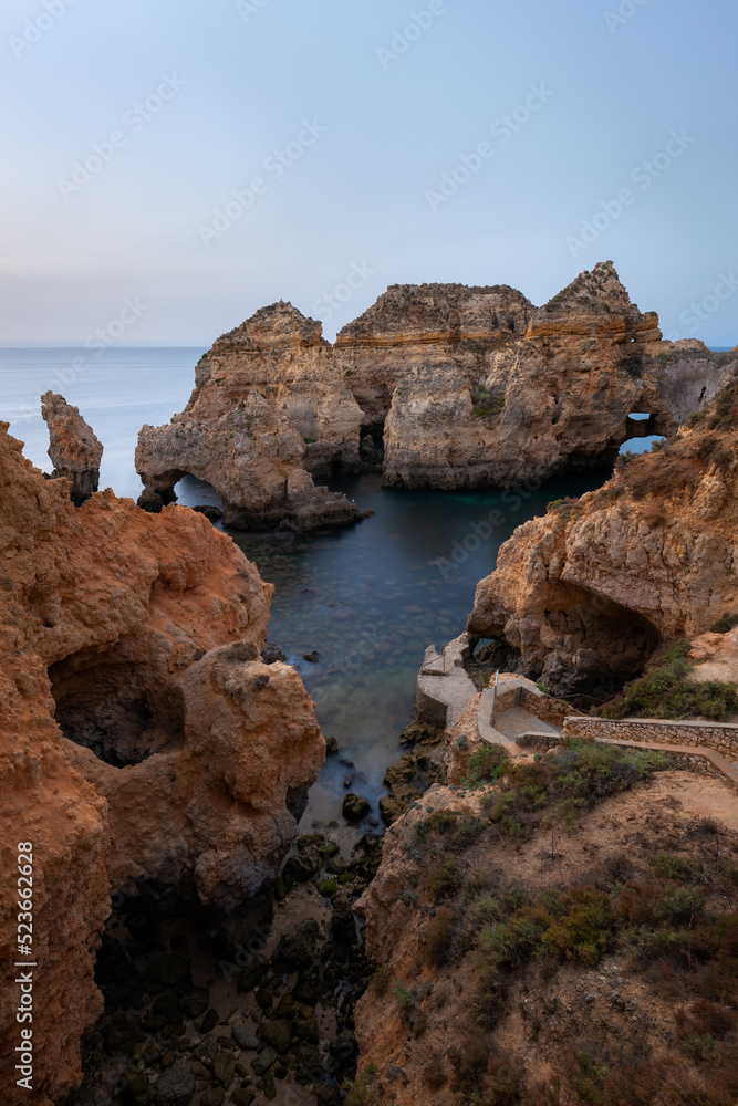Landscape with rocks and sea stacks at Ponta da Piedade, Lagos, Algarve (Portugal) at sunrise.