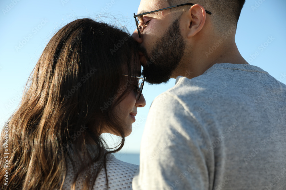 Happy young couple against blue sky. Honeymoon trip Happy young couple against blue sky. Honeymoon trip