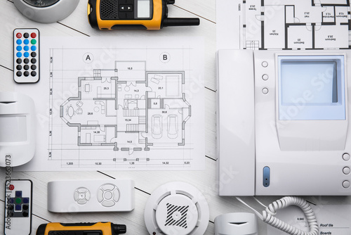 Fotografie Flat lay composition with equipment for home security system on white wooden tab