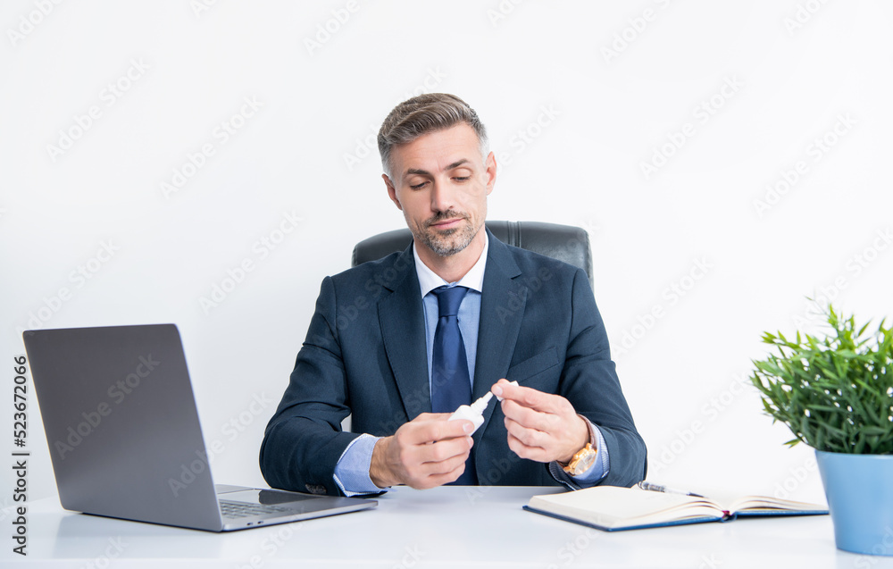 mature manager in business office opening nasal drops mature manager in business office opening nasal drops