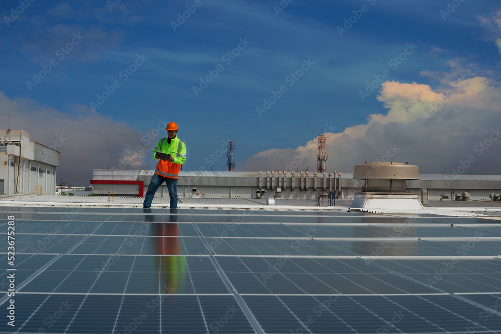 solar panel installation. Solar cells have been maintained and maintenance by a team of engineers.  two engineers checking solar cells on power plant background. 