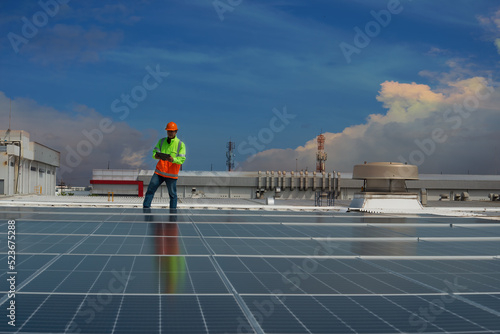 solar panel installation. Solar cells have been maintained and maintenance by a team of engineers. two engineers checking solar cells on power plant background. 