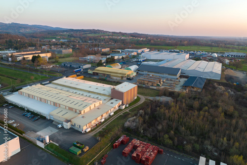 Aerial view of goods warehouses and logistics center in industrial city zone from above