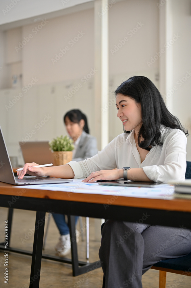 Professional Asian businesswoman working, using laptop computer at her office Professional Asian businesswoman working, using laptop computer at her office