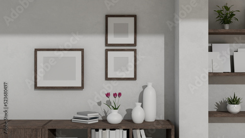 Copy space on wooden low-cabinet against the white wall with empty picture frame mockup © bongkarn