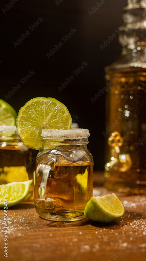 tequila shots served in jars with salt and lime on wooden table tequila shots served in jars with salt and lime on wooden table
