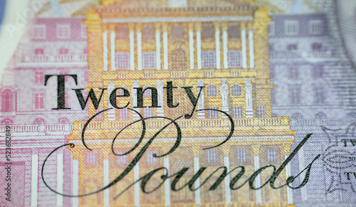 A closeup of £20 Twenty pounds cash money bill Sterling polymer banknote from the bank of England that features the queen and J. M. W. Turner, selective focus of a macro shot of United Kingdom money photo